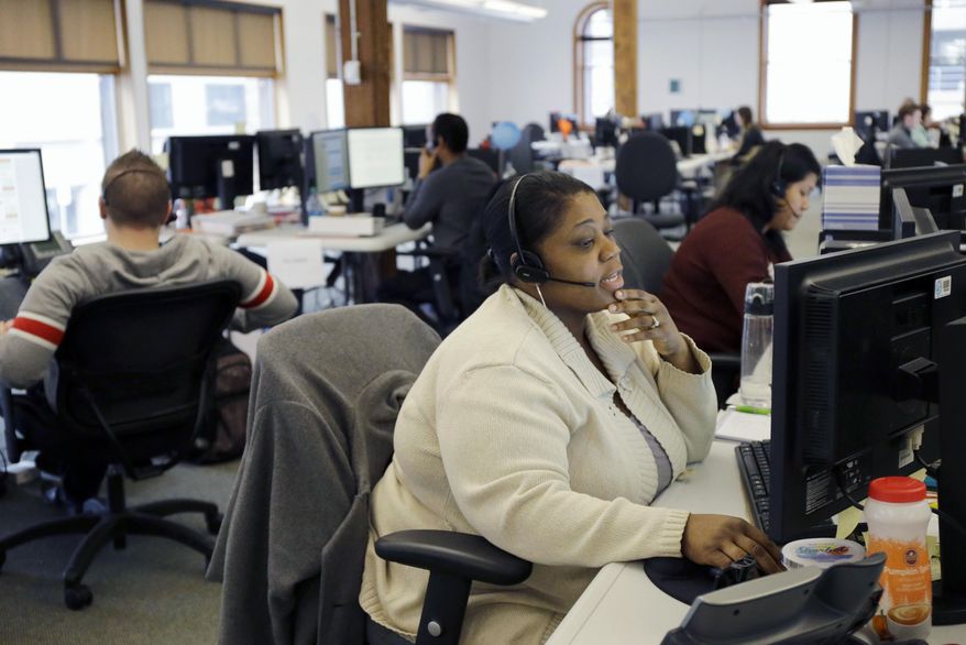 Loretha Cager talks with an applicant at MNSure's call center in St. Paul, Minn., Monday, March 31, 2014. Monday is the open enrollment deadline for signing up for insurance under the health care act. (AP Photo/Ann Heisenfelt)
