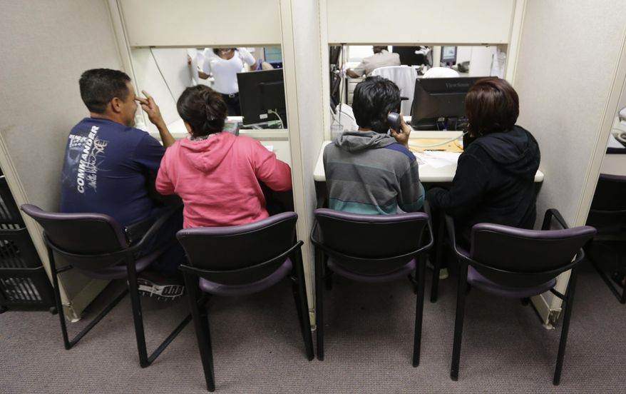 People use a a phone bank to sign up for health care insurance at the business office of Parkland Hospital in Dallas, Monday, March 31, 2014. Monday is the deadline to sign up for private heath insurance in the online markets created by President Obama's heath care law. (AP Photo/LM Otero)