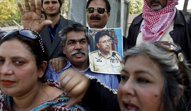 Supporters of the former Pakistani President Pervez Musharraf chant slogans outside the special court in Islamabad, Pakistan, Monday, March 31, 2014. A special Pakistani court Monday indicted former military ruler Pervez Musharraf on five counts of high treason, marking a sharp blow to the country’s powerful military. (AP Photo/B.K. Bangash)
