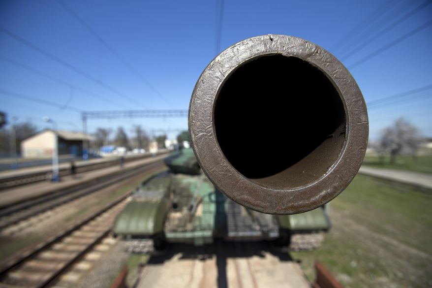 Ukrainian T-62 tanks are placed on a platform to be transported to Ukraine from the Ostryakovo railway station not far from Simferopol, Crimea, Monday, March 31, 2014. (AP Photo/Pavel Golovkin)