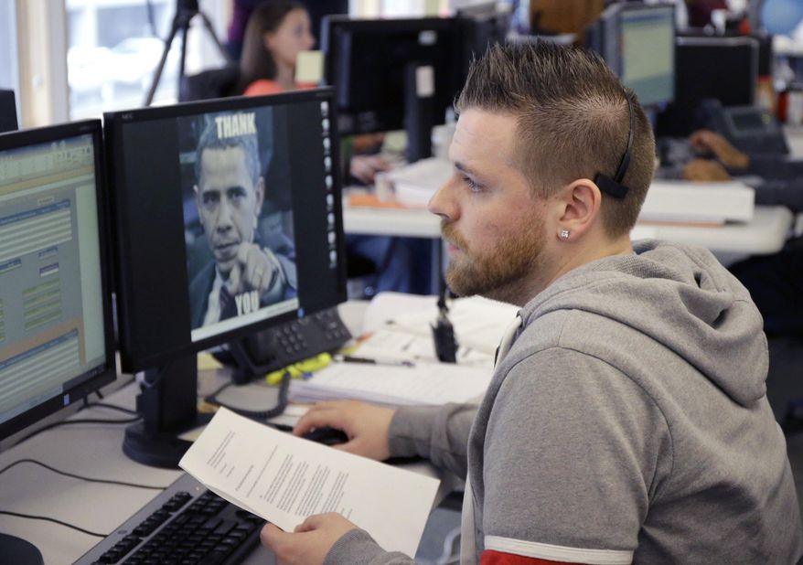 Joshua Truax talks with an applicant at MNSure's call center in St. Paul, Minn., Monday, March 31, 2014. Monday is the open enrollment deadline for signing up for insurance under the health care act. (AP Photo/Ann Heisenfelt)