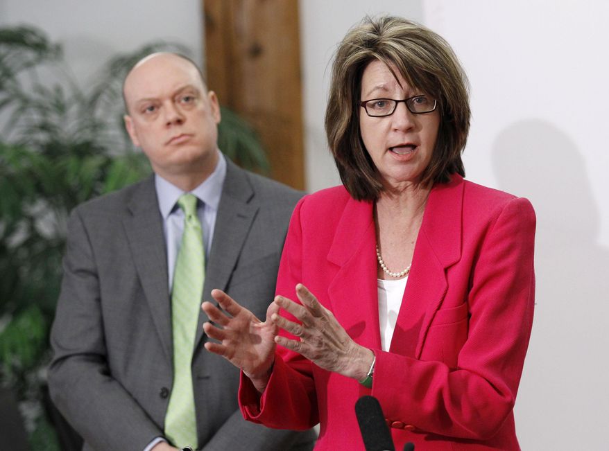 Lucinda Jesson, commissioner of the Minnesota Department of Human Services, speaks during news conference at MNSure's offices in St. Paul, Minn., Monday, March 31, 2014. Listening at left is interim CEO of MNSure, Scott Leitz. Monday is the open enrollment deadline for signing up for insurance under the health care act. (AP Photo/Ann Heisenfelt)