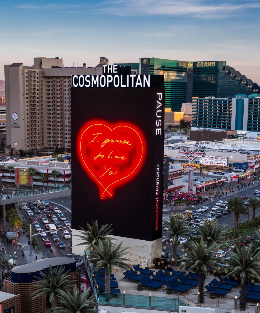 This photo provided by The Cosmopolitan shows a giant LED sign that displays love notes outside The Cosmopolitan on the Las Vegas Strip. The casino plans to start broadcasting the animated works of contemporary British artist Tracey Emin for about three minutes every hour, starting on Monday, March 31, 2014. Passersby will see about a dozen giant indoor and outdoor marquees go black, then hand written phrases such as "I promise to love ya" will appear in glowing letters. The Cosmopolitan says it's part of the casino's ongoing efforts to put interactive art in unexpected places, including the property's 65-foot-tall marquee. (AP Photo/The Cosmopolitan, Erik Kabik)