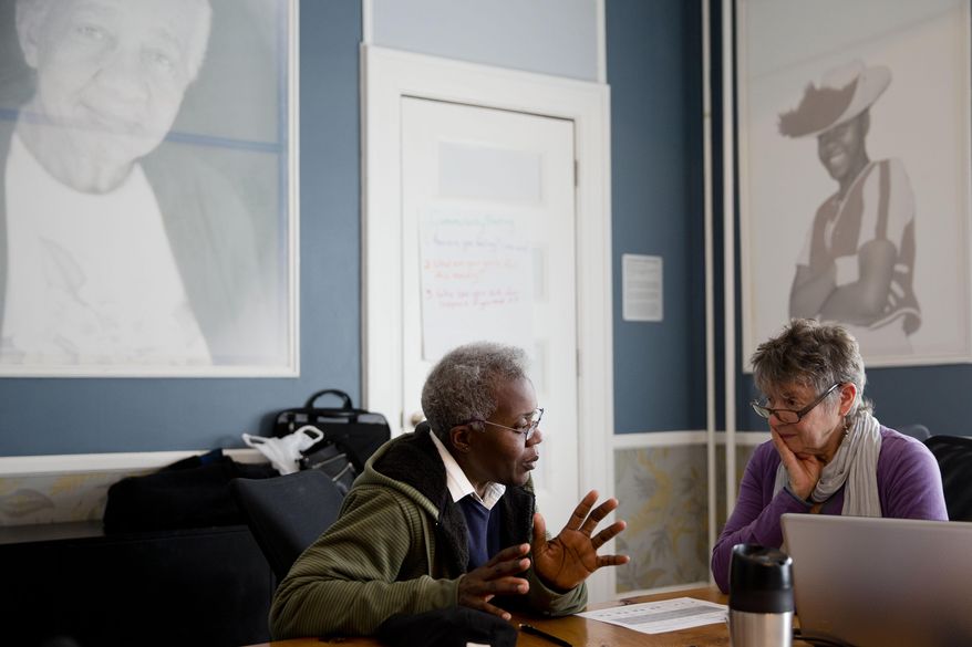 Shareda Green, left, meets with Barbara Bloomfield a volunteer with the Pennsylvania Health Access Network to begin the process of signing up for insurance under the Affordable Care Act, Monday, March 31, 2014, at Project HOME's St. Elizabeth’s Community and Wellness Center in Philadelphia. With the deadline’s just hours away to sign up for insurance in the first enrollment period under President Barack Obama’s signature health care law health care advocates in Pennsylvania were pushing Monday to get as many people as possible to sign up. (AP Photo/Matt Rourke)