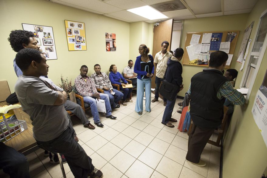People wait in line to buy health insurance at the Somali Bantu Community of Greater Houston, Monday March 31, 2014, in Houston. Monday is the deadline to sign up for private heath insurance in the online markets created by President Obama's heath care law. (AP Photo/Michael Stravato)