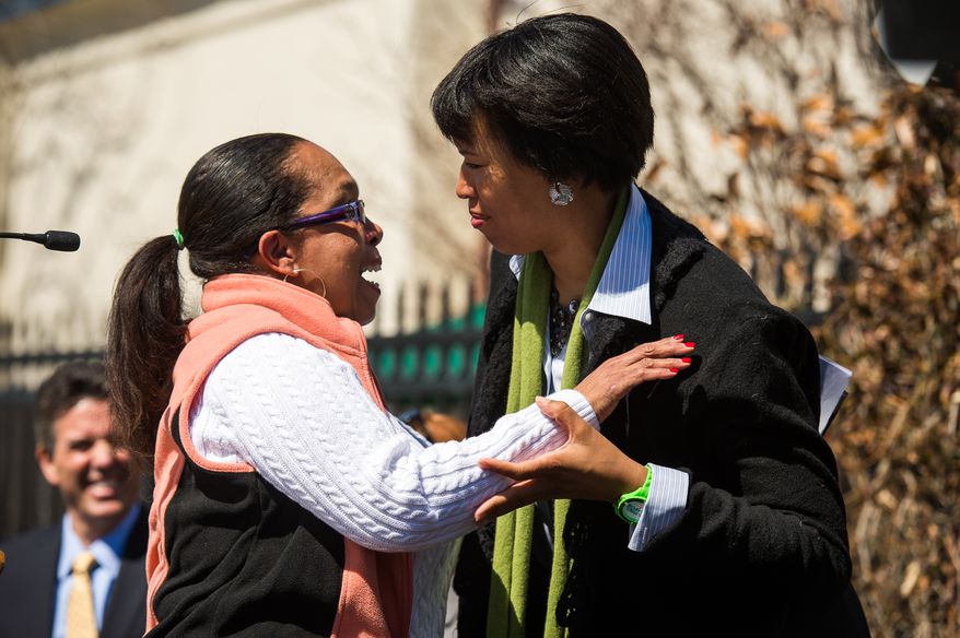 Delma Johnson gets a hug from Mayoral candidate Councilmember Muriel Bowser (D-Ward 4) after she tells her story about how her dog was saved by the Animal Rescue League when she was unable to afford medical bills for the dog, during a Washington Animal Rescue League 100th Anniversary Celebration, Washington, D.C., Monday, March 31, 2014. (Andrew Harnik/The Washington Times)