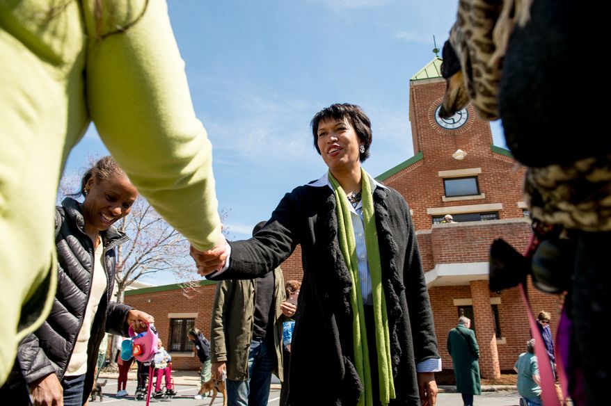 Mayoral candidate Councilmember Muriel Bowser (D-Ward 4) greets District residents after attending a Washington Animal Rescue League 100th Anniversary Celebration, Washington, D.C., Monday, March 31, 2014. (Andrew Harnik/The Washington Times)