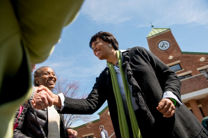 Mayoral candidate Councilmember Muriel Bowser (D-Ward 4) greets District residents after attending a Washington Animal Rescue League 100th Anniversary Celebration, Washington, D.C., Monday, March 31, 2014. (Andrew Harnik/The Washington Times)