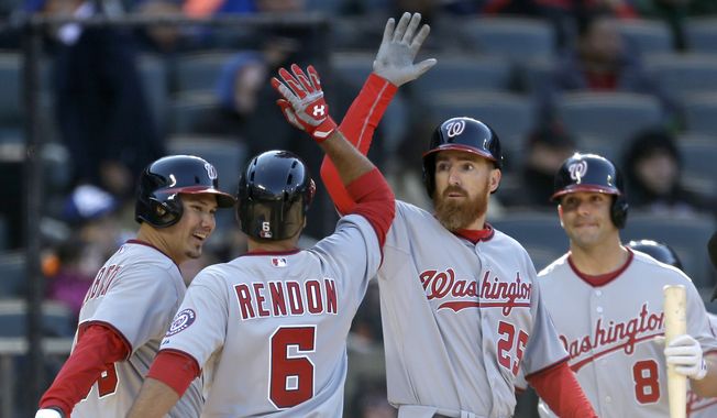 Washington Nationals&#x27; Anthony Rendon, second from left, celebrates his three-run home run with teammates Danny Espinosa, right, Adam LaRoche, second from right, and Jose Lobaton during the tenth inning of the baseball game against the New York Mets on Opening Day at Citi Field in New York, Monday, March 31, 2014. The Nationals defeated the Mets in extra innings 9-7. (AP Photo/Seth Wenig)