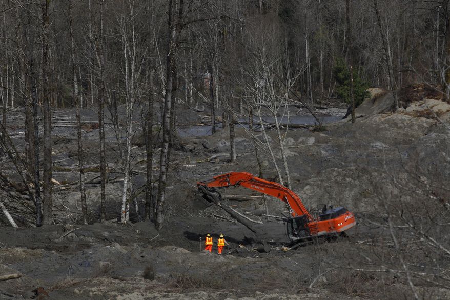 Workers and volunteers search for articles and belongings at the scene of the deadly March 22 mudslide, Monday, March 31, 2014, in Oso, Wash. The number of confirmed dead has reached 24. More than two dozen people remain missing, authorities have said. (AP Photo/The Herald, Sofia Jaramillo, Pool)