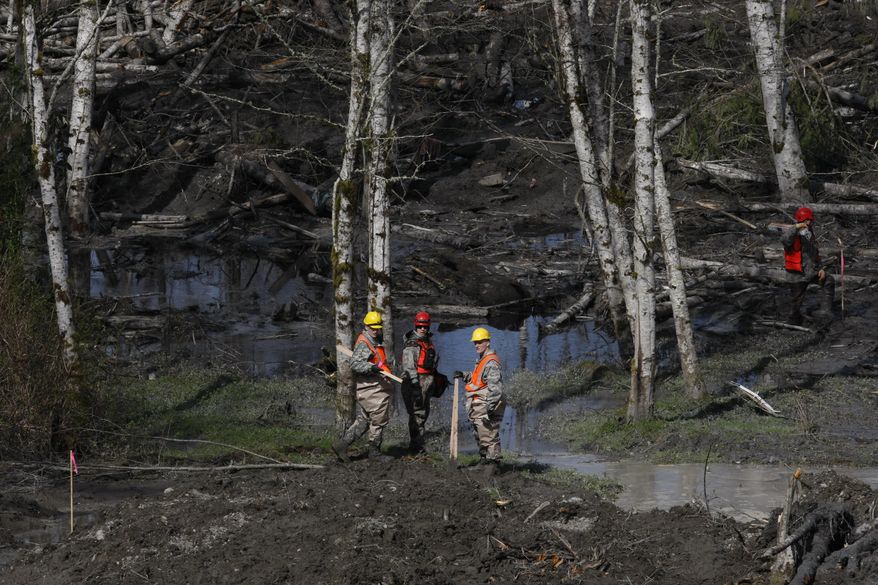 Workers search for articles and belongings at the scene of the deadly March 22 mudslide, Monday, March 31, 2014, in Oso, Wash. The number of confirmed dead has reached 24. More than two dozen people remain missing, authorities have said. (AP Photo/The Herald, Sofia Jaramillo, Pool)
