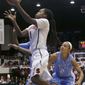 Stanford guard Lili Thompson (1) shoots against North Carolina guard Latifah Coleman (2) and forward Stephanie Mavunga, left rear, during the first half of a regional final of the NCAA women&#39;s college basketball tournament in Stanford, Calif., Tuesday, April 1, 2014. (AP Photo/Jeff Chiu)