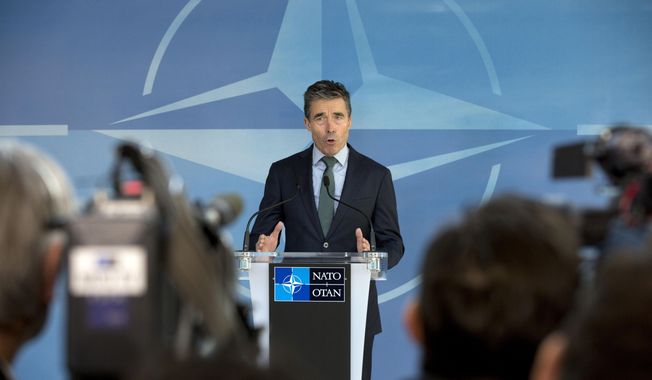 NATO Secretary General Anders Fogh Rasmussen gestures while speaking during a media conference ahead of a meeting of the North Atlantic Council at NATO headquarters in Brussels on Tuesday, April 1, 2014. NATO foreign ministers begin a two-day meeting on Tuesday in which they will discuss, among other issues, the situation in Ukraine. (AP Photo/Virginia Mayo)