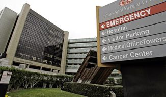FILE - This Jan. 4, 2008 file photo, shows the exterior of Cedars-Sinai Medical Center in Los Angeles. A former nursing assistant at Cedars-Sinai is under investigation after two women said they were sexually assaulted while being treated at the hospital. (AP Photo/Nick Ut, File)