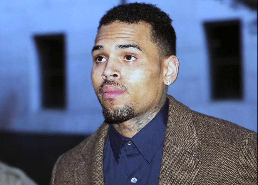 FILE - In this Feb. 3, 2014 file photo, R&B singer Chris Brown arrives at a Los Angeles Superior Court for a probation review hearing in Los Angeles. A judge scheduled a hearing for Thursday April 3, 2014, on whether Brown should be released to the custody of U.S. marshals so he can appear at an upcoming assault trial in Washington, D.C. Superior Court Judge James R. Brandlin met with attorneys in chambers on Tuesday April 1, 2014, but did not rule on a request by Brown's lawyers to keep him in a Los Angeles until the trial. (AP Photo/Nick Ut, file)