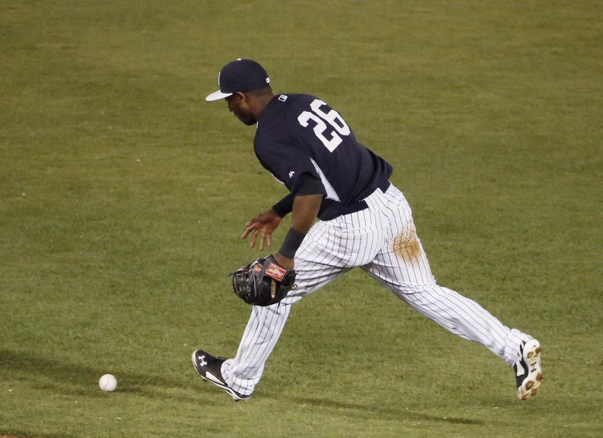 In this photo taken on March 28, 2014, New York Yankees shortstop Eduardo Nunez chases down a ball hit by Miami Marlins' Jarrod Saltalamacchia during the ninth inning of a spring exhibition baseball game in Tampa, Fla. Nunez was charged with an error on the play. Yankees manager Joe Girardi announced Saturday, March, 29, that Yangervis Solarte beat out Nunez for a backup infield job. Nunez, who played in 90 games for the Yankees last year, was optioned to Triple-A Scranton/Wilkes-Barre. (AP Photo/Kathy Willens)