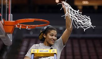 Maryland forward Alyssa Thomas (25) holds up the net after Maryland defeated Louisville 76-73 in an NCAA women&#39;s college basketball tournament regional final, Tuesday, April 1, 2014, in Louisville, Ky. (AP Photo/John Bazemore)