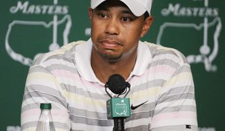 FILE - In this April 5, 2010 file photo, Tiger Woods listens to a question during his news conference at the Masters golf tournament in Augusta, Ga. Woods will miss the Masters for the first time in his career after having surgery on his back. Woods said on his website that he had surgery Monday, March 31, 2014, in Utah for a pinched nerve that had been hurting him for several months. (AP Photo/Harry How, Pool, File)