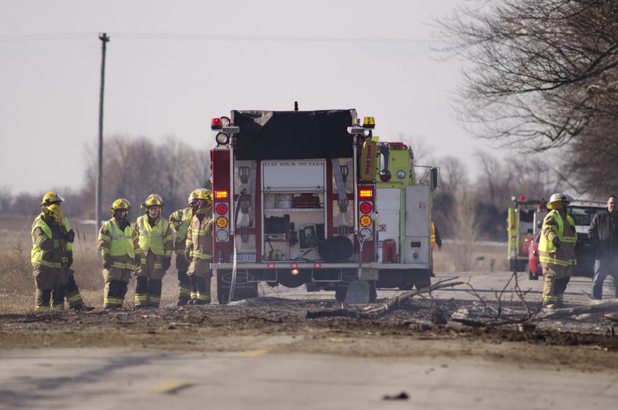 Richville Fire Department investigate a tanker crash in Reese, Mich. Wednesday, April 2, 2014. Authorities say one person is dead following a fuel tanker crash in rural Michigan that sent flames 150 to 200 feet into the air. Richville Fire Chief Eric Brown says the truck was carrying about 13,000 gallons of fuel. (AP Photo/The Saginaw News, Tim Goessman) ALL LOCAL TV OUT; LOCAL TV INTERNET OUT MBO (REV-SHARE)