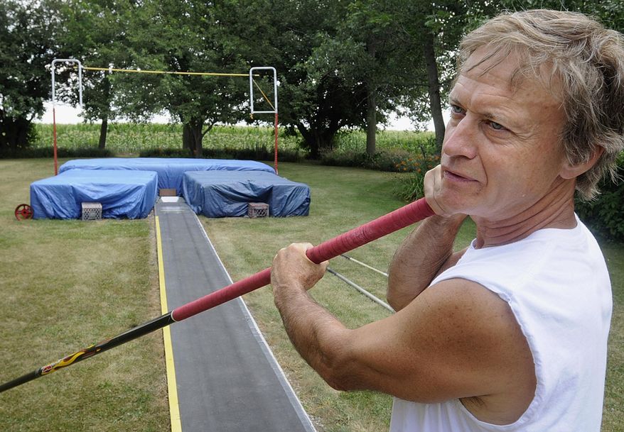 FILE - In this July 22, 2013 file photo, Larry LaGesse, prepares to pole vault in the backyard training center he built at his rural Chebanse, Ill., home. The 66-year-old Bradley-Bourbonnais Community High School product turned in a championship performance in his first National Masters Indoor Heptathlon, held in March at Carthage College in Wisconsin. (AP Photo/The Daily Journal, Mike Voss, File)