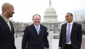 From left, former Northwestern University football quarterback Kain Colter, Ramogi Huma, founder and President of the National College Players Association and Tim Waters, Political Director of the United Steel Workers, arrive on Capitol Hill in Wednesday, April, 2, 2014. Members of a group seeking to unionize college athletes are looking for allies on Capitol Hill as they brace for an appeal of a ruling that said full scholarship athletes at Northwestern University are employees who have the right to form a union. Former Northwestern quarterback Kain Colter _ the face of a movement to give college athletes the right to unionize _ and Ramogi Huma, the founder and president of the National College Players Association, scheduled meetings Wednesday with lawmakers. (AP Photo/Lauren Victoria Burke)