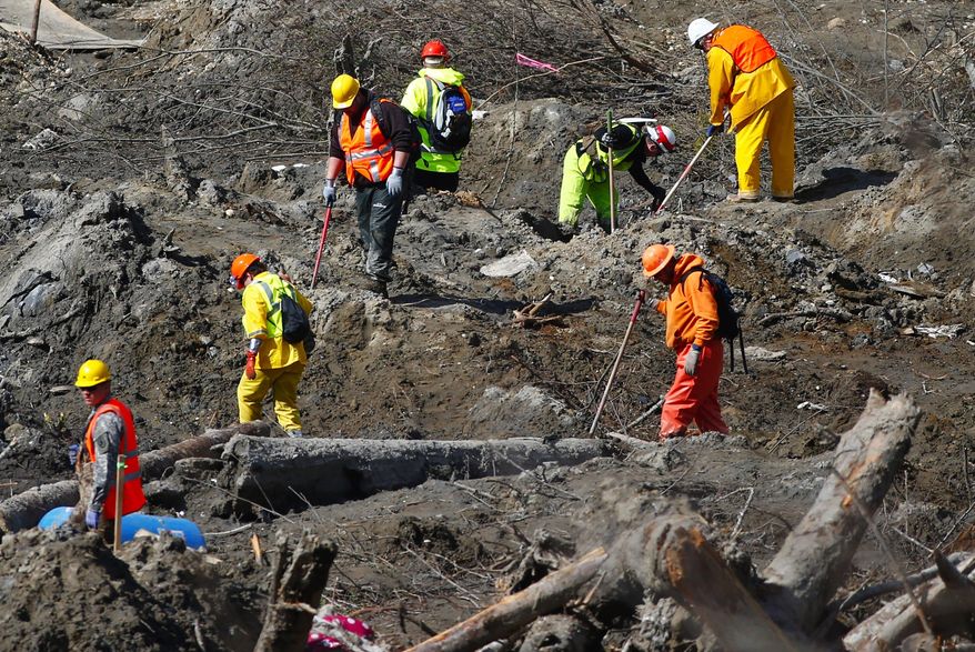 Workers dig at a much drier mudslide site on the west side at the west site of the mudslide on Highway 530 near mile marker 37, near Oso, Wash., on Tuesday, April 1, 2014. The death toll from the March 22 mudslide has increased to 28. (AP Photo/The Seattle Times, Lindsey Wasson) SEATTLE OUT; USA TODAY OUT; MAGS OUT; TELEVISION OUT; NO SALES; MANDATORY CREDIT TO BOTH THE SEATTLE TIMES AND THE PHOTOGRAPHER