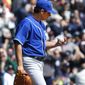 Kansas City Royals pitcher Jason Vargas looks at a ball after allowing a Detroit Tigers&#39; Ian Kinsler solo home run in the fourth inning of a baseball game in Detroit Wednesday, April 2, 2014. (AP Photo/Paul Sancya)