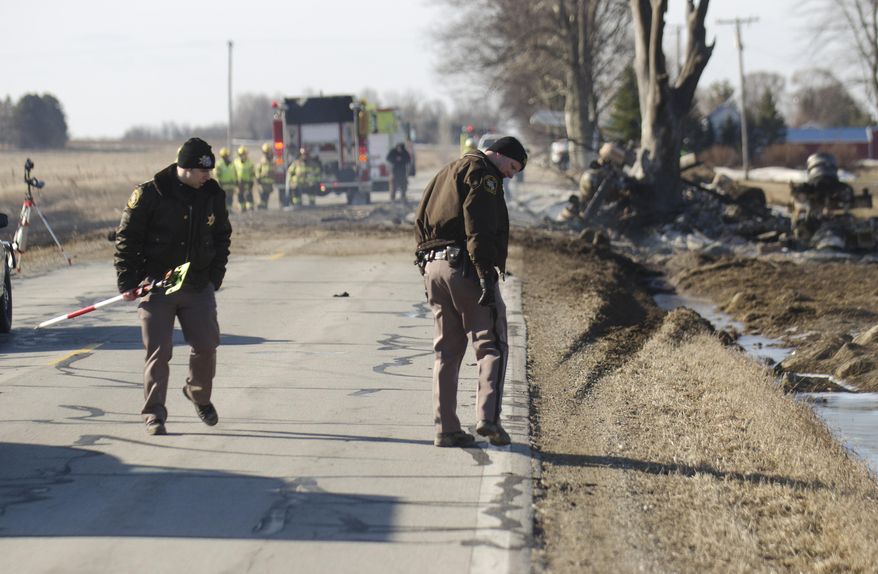 The Tuscola County Sheriffs department investigate the scene of a tanker crash in Reese, Mich. Wednesday, April 2, 2014. Authorities say one person is dead following a fuel tanker crash in rural Michigan that sent flames 150 to 200 feet into the air. Richville Fire Chief Eric Brown says the truck was carrying about 13,000 gallons of fuel. (AP Photo/The Saginaw News, Tim Goessman) ALL LOCAL TV OUT; LOCAL TV INTERNET OUT