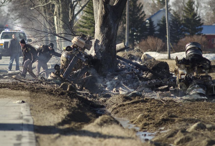 The Tuscola County Sheriffs department investigate the scene of a tanker crash in Reese, Mich. Wednesday, April 2, 2014. Authorities say one person is dead following a fuel tanker crash in rural Michigan that sent flames 150 to 200 feet into the air. Richville Fire Chief Eric Brown says the truck was carrying about 13,000 gallons of fuel. (AP Photo/The Saginaw News, Tim Goessman) ALL LOCAL TV OUT; LOCAL TV INTERNET OUT