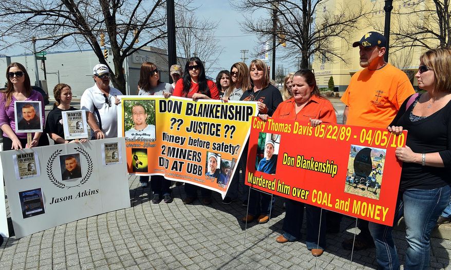 Friends and families of the 29 victims of the Upper Big Branch Mine explosion gather in front of the Robert C. Byrd Federal Courthouse in Charleston, W.Va., Wednesday April 2, 1014. Wednesday's gathering commemorated the disaster. Saturday is the four-year anniversary of the explosion. (AP Photo/Charleston Daily Mail, Craig Cunningham)