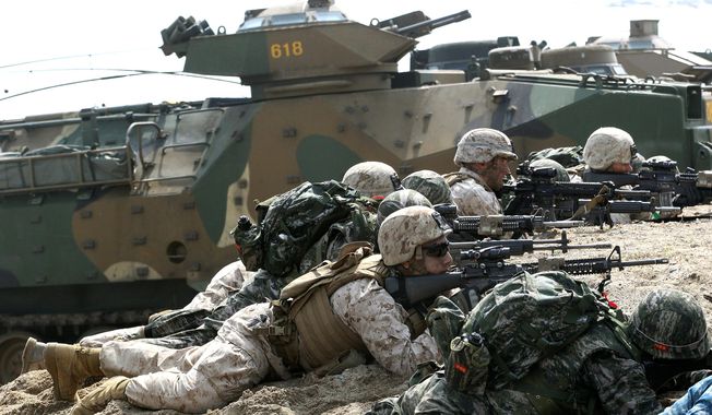 South Korean and U.S. Marines aim their machine guns during the U.S.-South Korea joint landing exercises called Ssangyong, part of the Foal Eagle military exercises, in Pohang, South Korea. (Associated Press)