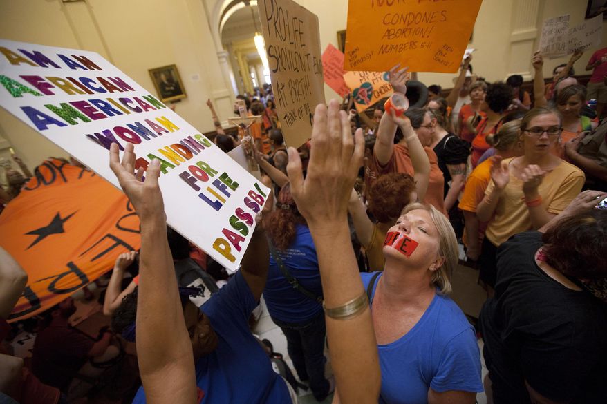 FILE - In this July 12, 2013 file photo, opponents and supporters of abortion rights rally in the State Capitol rotunda in Austin, Texas. An advocacy group filed another federal lawsuit Wednesday, April 2, 2014, challenging a new provision in Texas' tough restrictions on abortion. The Center for Reproductive Rights asked an Austin-based judge to block enforcement of key portions of the law, including some which have yet to take effect. (AP Photo/Tamir Kalifa, File)