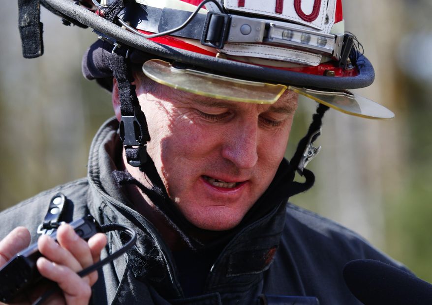 Bellevue Fire Department Lt. Richard Burke answers media questions at the west site of the mudslide on Highway 530, near Oso, Wash., on Tuesday, April 1, 2014. The death toll from the March 22 mudslide has increased to 28. (AP Photo/The Seattle Times, Lindsey Wasson) SEATTLE OUT; USA TODAY OUT; MAGS OUT; TELEVISION OUT; NO SALES; MANDATORY CREDIT TO BOTH THE SEATTLE TIMES AND THE PHOTOGRAPHER