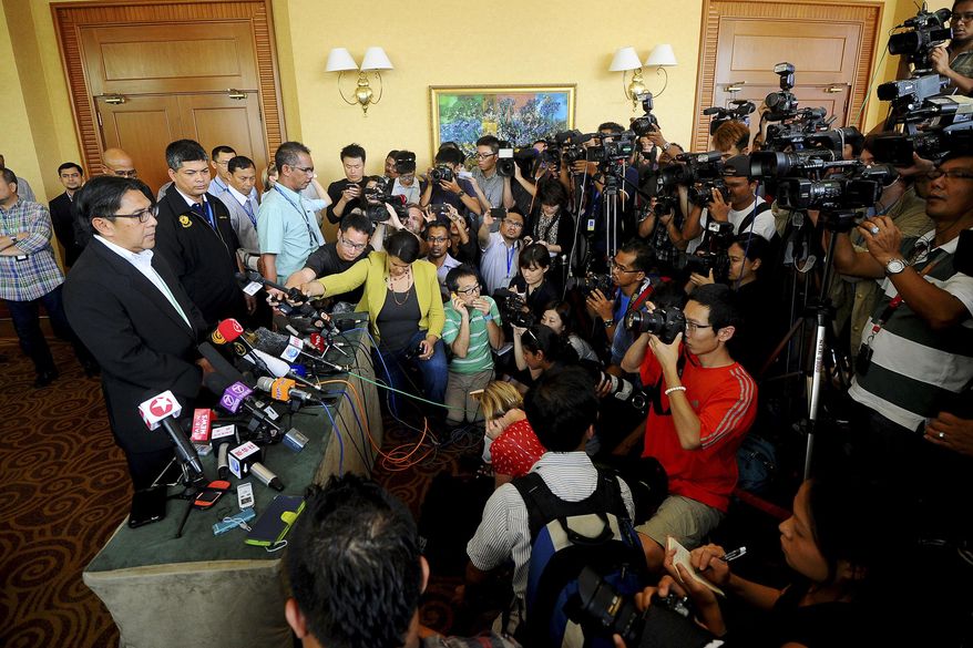 Malaysia's civil aviation chief Azharuddin Abdul Rahman, left, speaks during a press conference after a close door meeting with Chinese relatives of the passengers onboard the missing Malaysia Airlines Flight 370 at a hotel in Bangi, on the outskirts of Kuala Lumpur, Malaysia, Wednesday, April 2, 2014. The plane disappeared March 8 on a flight to Beijing from Kuala Lumpur after its transponders, which make the plane visible to commercial radar, were shut off. A multinational team of aircraft and ships are searching the southern Indian Ocean for the plane, but have yet to find any sign of the Boeing 777. (AP Photo/Joshua Paul)