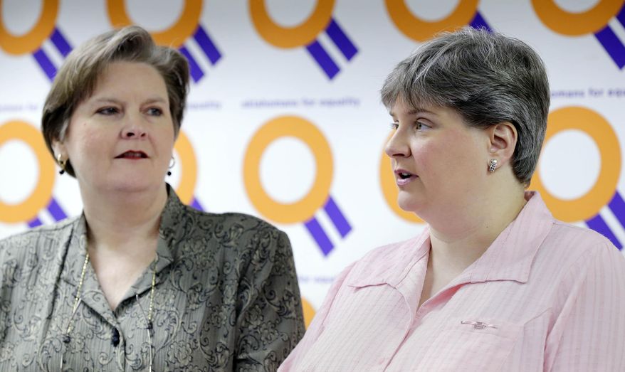 FILE - In this March 17, 2014 file photo, Mary Bishop, left, listens as her partner Sharon Baldwin speaks about the status of appeals in the ongoing Oklahoma same sex marriage fight during a news conference at the Dennis R. Neill Equality Center in Tulsa, Okla. In a brief filed Tuesday, April 1, 2014, lawyers for an Oklahoma clerk who refused to grant a marriage license to Bishop and Baldwin say marriage exists for its procreative potential and that the U.S. Supreme Court agrees. (AP Photo/Tulsa World, Michael Wyke, File) ONLINE OUT; KOTV OUT; KJRH OUT; KTUL OUT; KOKI OUT; KQCW OUT; KDOR OUT; TULSA OUT; TULSA ONLINE OUT