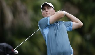 Russell Hunley watches from the 13th tee during the first round of the Cadillac Championship golf tournament Thursday, March 6, 2014, in Doral, Fla. (AP Photo/Wilfredo Lee)