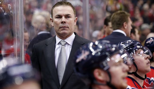 Washington Capitals head coach Adam Oates stands in the bench in the first period of an NHL hockey game against the Los Angeles Kings, Tuesday, March 25, 2014, in Washington. (AP Photo/Alex Brandon)