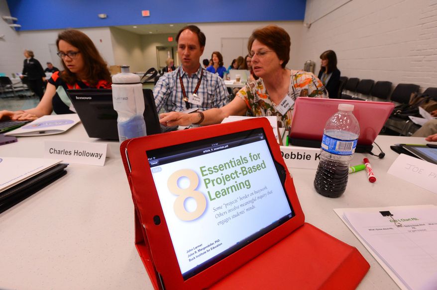 Alana Haughboo, Charles Holloway and Debbie Kirby participate in a project based learning workshop for teachers and administrators at Leon Sheffield Elementary School in Decatur, Ala., Wednesday, April 2, 2014. Decatur City Schools have been selected for a pilot program in the Project Based Learning initiative. (AP Photo/The Decatur Daily, Gary Cosby Jr.)