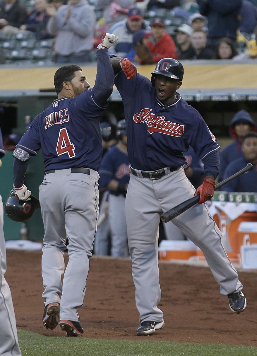 Cleveland Indians&#x27; Mike Aviles (4) is congratulated by  Nyjer Morgan after hitting a two-run home run  during the fourth inning of a baseball game in Oakland, Calif., Wednesday, April 2, 2014. (AP Photo/Jeff Chiu)