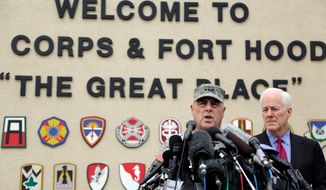 Lt. Gen. Mark Milley (left) and Sen. John Cornyn, Texas Republican, talk to the media near Fort Hood&#39;s main gate one day after a soldier opened fire on fellow service members at the Fort Hood military base, killing three people and wounding 16 before committing suicide. (Associated Press)