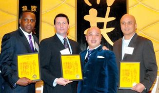 FILE - In this file photo taken March 16, 2011, Raymond &amp;quot;Shrimp Boy&amp;quot; Chow, second from right, poses with several inducted consultants, including Keith Jackson, left, a former San Francisco school board member, at the Chee Kung Tong spring banquet in San Francisco. Jackson, who is playing a key role in the cash-for-guns political corruption investigation that has ensnared California state Sen. Leland Yee, appeared in federal court Thursday, April 3, 2014 for a bail hearing on charges that include bribery, drugs, guns and murder-for-hire conspiracy. Jackson was ordered released from jail pending trial. (AP Photo/Sing Tao Daily, File)