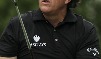 Phil Mickelson tees off on the fifth hole during the first round of the Shell Houston Open golf tournament, Thursday, April 3, 2014, in Humble Texas. (AP Photo/Patric Schneider)