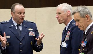 U.S. Air Force Gen. Philip Breedlove, left, the Supreme Allied Commander in Europe, speaks to colleagues during a meeting of the North Atlantic Council with Non-NATO ISAF Contributing Nations at NATO headquarters in Brussels on Wednesday, April 2, 2014. (AP Photo/Virginia Mayo)