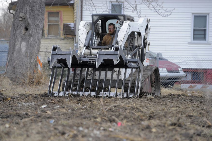Andy Williams an employee with Hantz Farms clears a lot, Tuesday March 25, 2014, on Crane near Goethe in Detroit's east side. A mass tree-planting effort is planned for May as part of a large-scale project. The May 17 event is planned by John Hantz where volunteers will help plant 15,000 young maple and oak trees on 50 acres of land where crews have been clearing blighted properties for the project. For the planting day, crews expect to have 15,000 pre-drilled holes ready. (AP Photo/Detroit News, Steve Perez) DETROIT FREE PRESS OUT; HUFFINGTON POST OUT