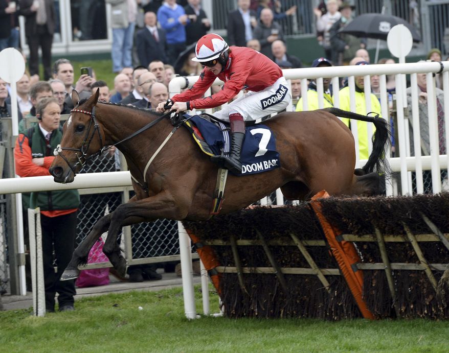The New One ridden by Sam Twiston Davies clear a hurdle as they go onto win the Doom Bar Aintree Hurdle during the opening day of the Aintreee Festival at Aintree Racecourse, Liverpool England Thursday April 3, 2014. (AP Photo/John Giles/PA) UNITED KINGDOM OUT