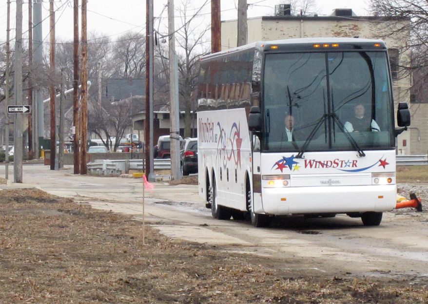 A bus carrying members of the Iowa Racing and Gaming Commission tours the site of a proposed casino in Cedar Rapids, Iowa on Thursday, April 3, 2014. The commission held a public hearing as it considers whether to approve the project, which is opposed by some existing casinos. (AP Photo/Ryan J. Foley)