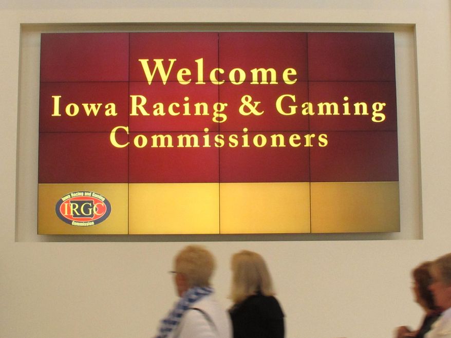 A sign welcomes members of the Iowa Racing and Gaming Commission at a hotel in Cedar Rapids, Iowa, on Thursday, April 3, 2014, as members of the public arrive for a hearing on a proposed casino in the city. The commission is considering whether to approve the project, which is opposed by some existing casinos. (AP Photo/Ryan J. Foley)