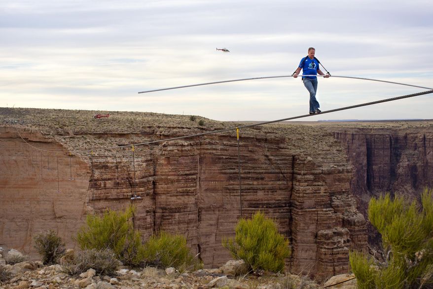 FILE - This June 23, 2013 file photo released by Discovery shows Nik Wallenda walking across the Grand Canyon for Discovery Channel's "Skywire Live With Nik Wallenda" at Grand Canyon National Park in Arizona. allenda is taking his tightrope to Chicago for a high-wire walk to be televised this fall on Discovery, part of the network's strategy to entice viewers with live events. Wallenda's walk across the Grand Canyon last year reached more than 10 million viewers live on Discovery. His encore will probably take place in November, Discovery said on Thursday, April 3, 2014. (AP Photo/Discovery, Tiffany Brown, File)