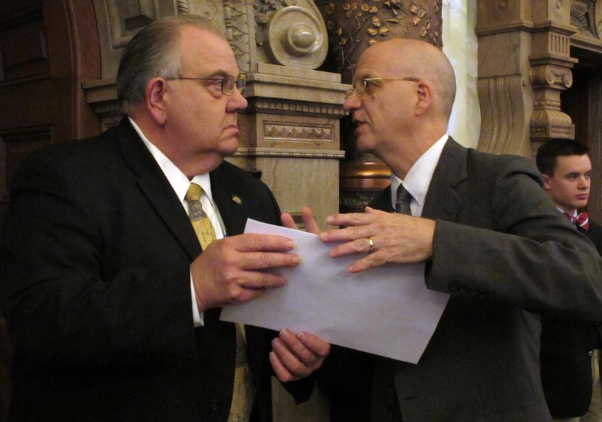 Kansas state Sen. Steve Abrams, left, an Arkansas City Republican, confers with J.G. Scott, the Kansas Legislative Research Department's chief fiscal analyst, during a debate on a school funding plan, Thursday, April 3, 2014, at the Statehouse in Topeka, Kan. Lawmakers are working on a plan to boost aid to poor school districts. (AP Photo/John Hanna)