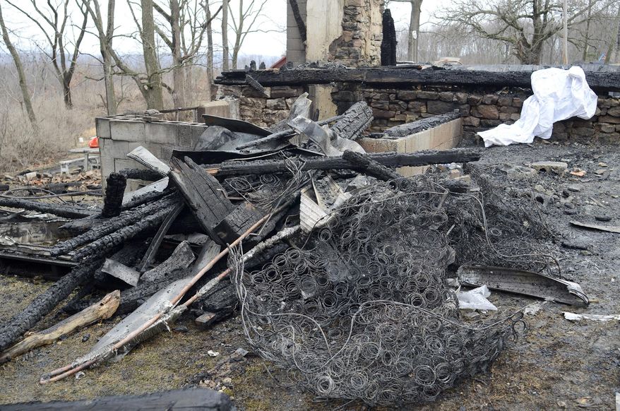 Charred debris is along the edge of the foundation of where three children were killed in a fire that destroyed the home in Danville Pa., Northumberland County, on Friday April, 4, 2014. (AP Photo/Daily Item, Bill Inglis)